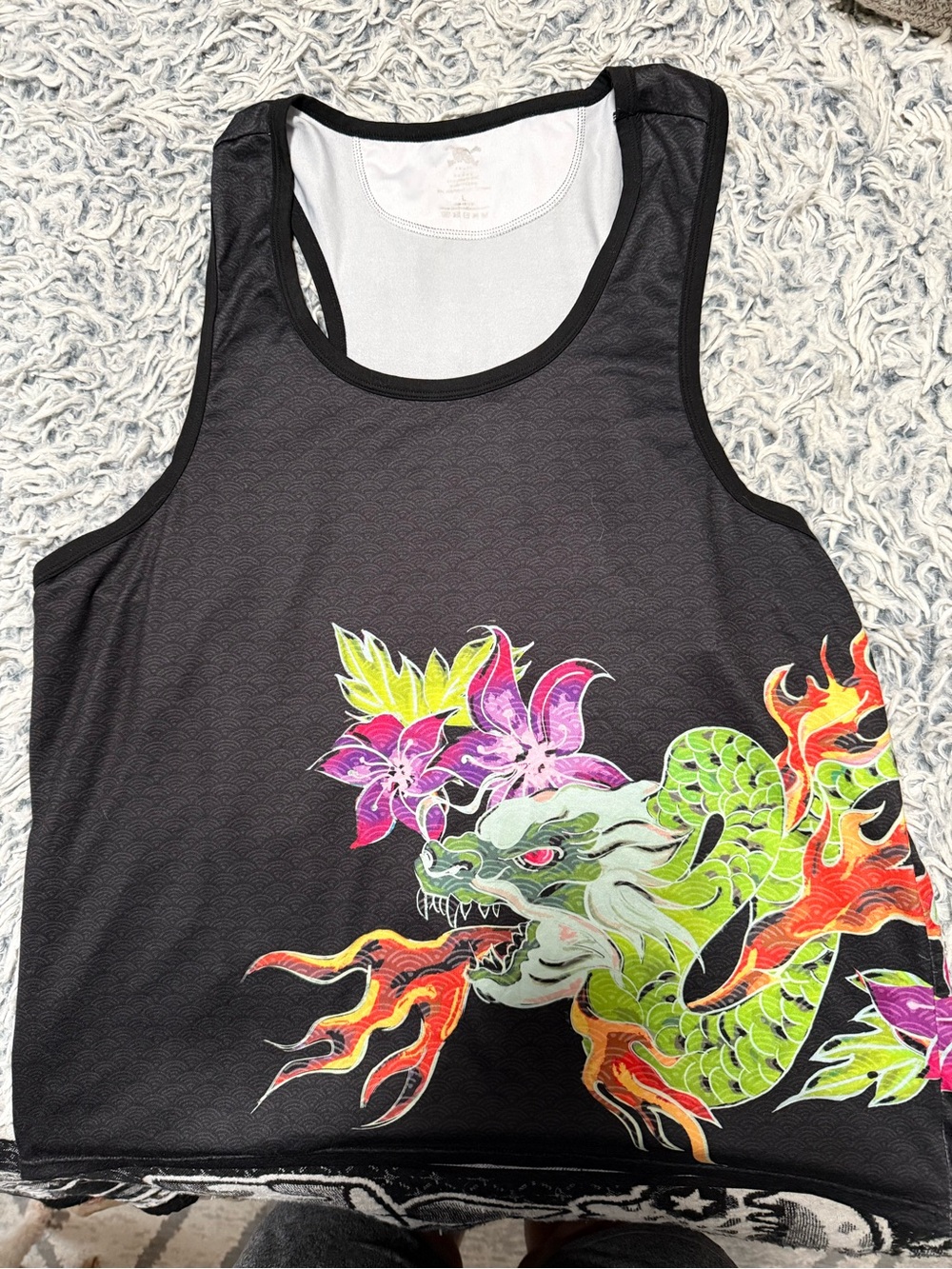 Skull & Bones men’s tank top. It is black with a dragon wrapped around.